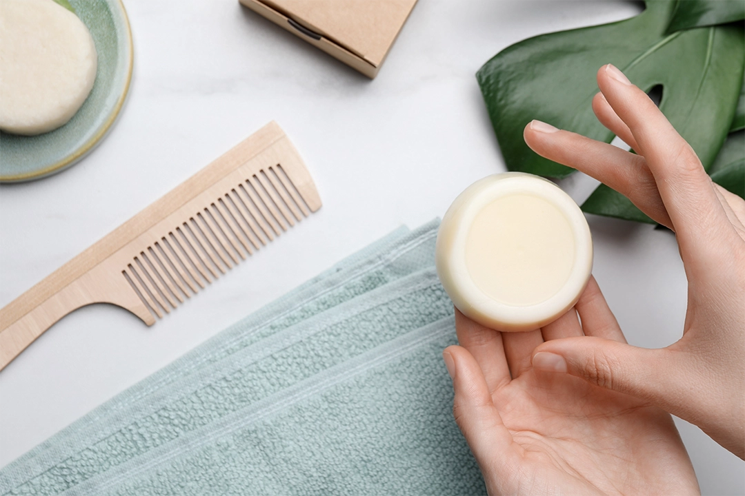 Woman holding solid shampoo